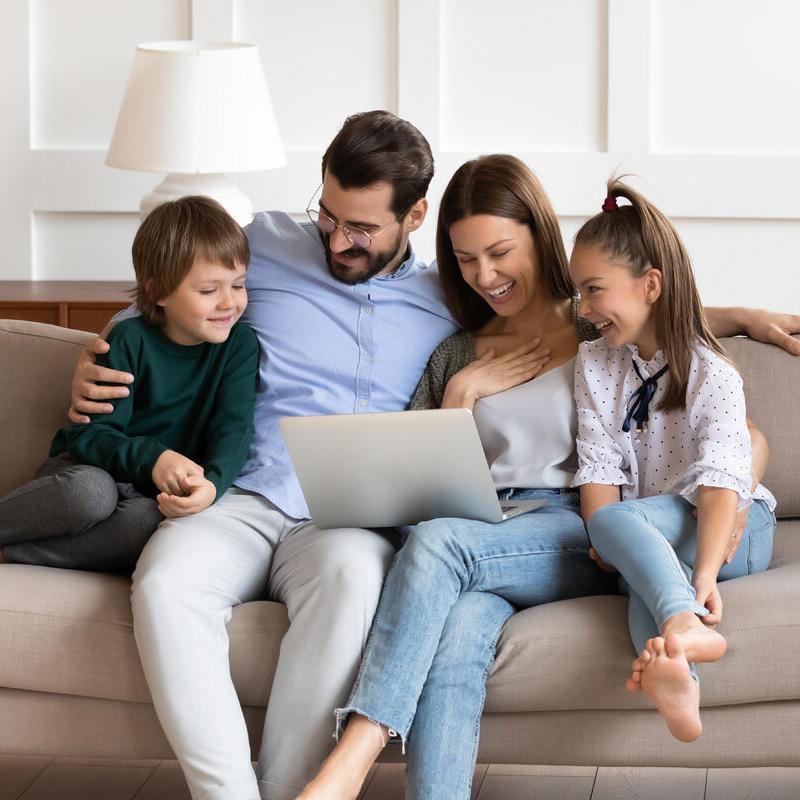 Familie testet Online-Finanzierungsrechner am Laptop