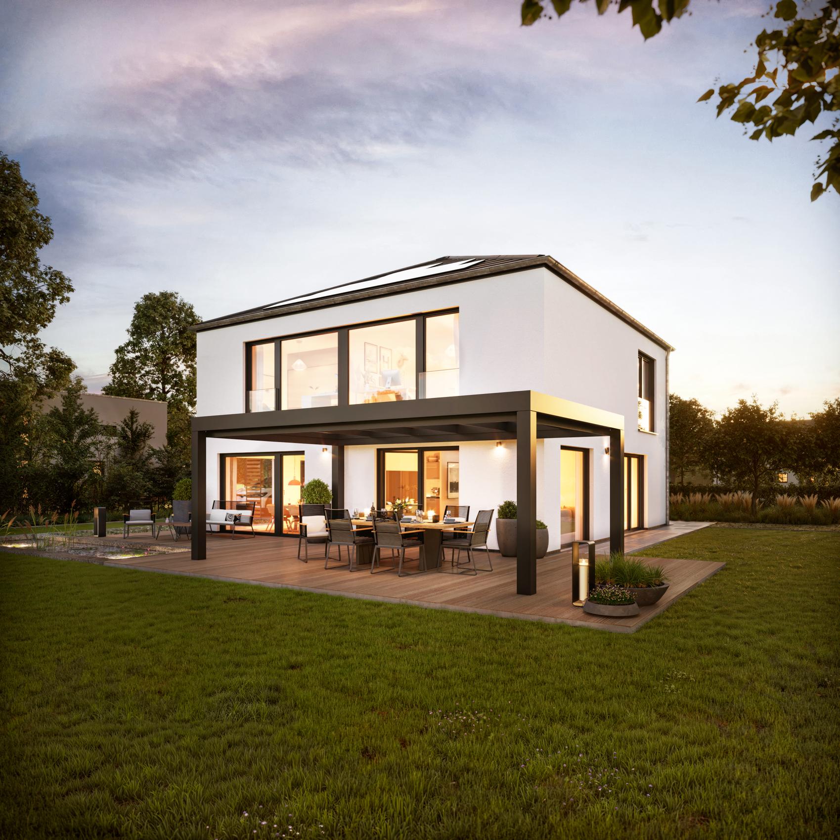 Satteldach Einfamilienhaus bei Dämmerung mit beleuchteten Fenstern in Oldenburg