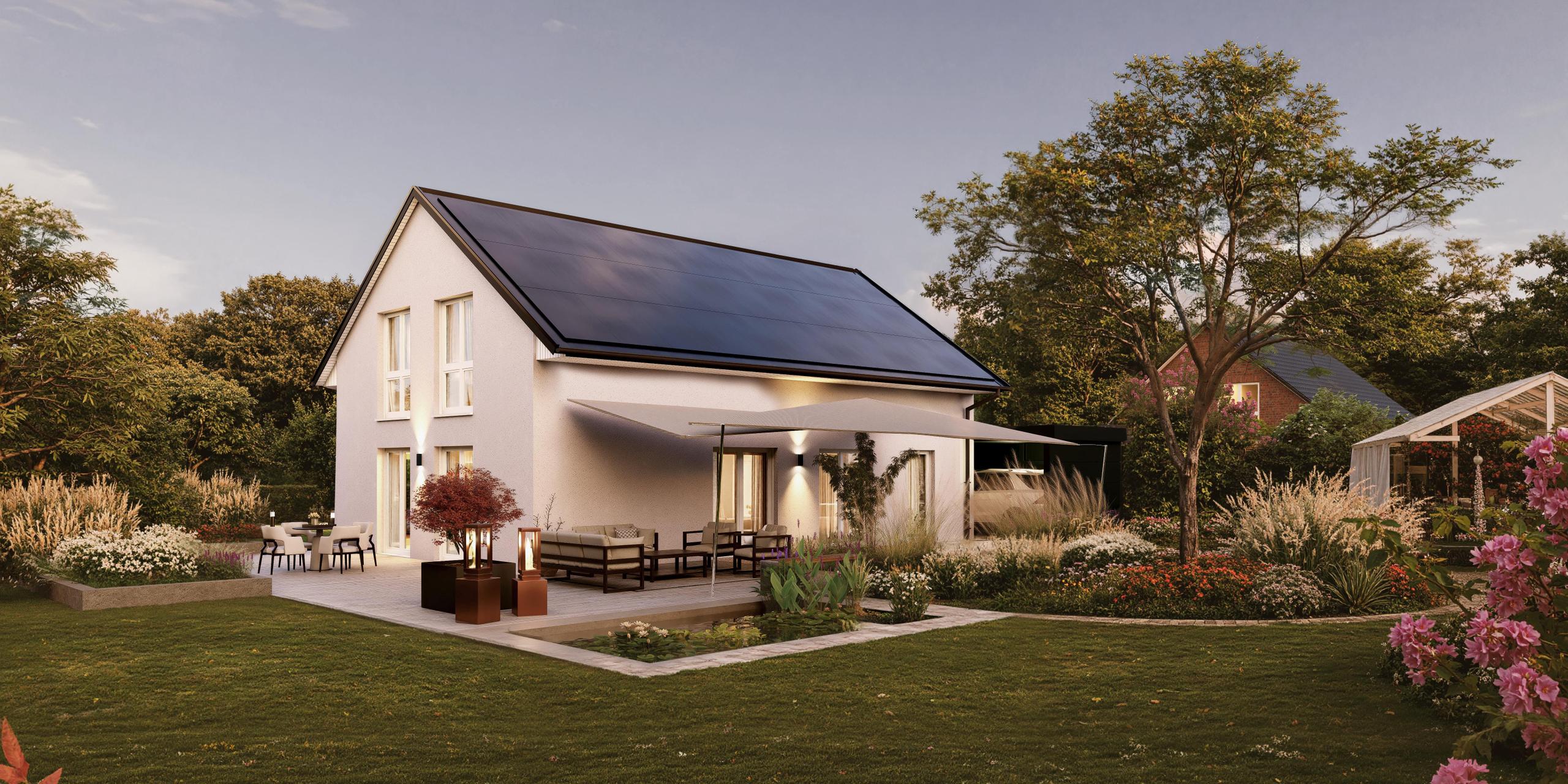Gartenansicht eines Einfamilienhauses mit Putz und einem großen Power Roof auf dem Dach. Es handelt sich um das V2 Limited von Viebrockhaus