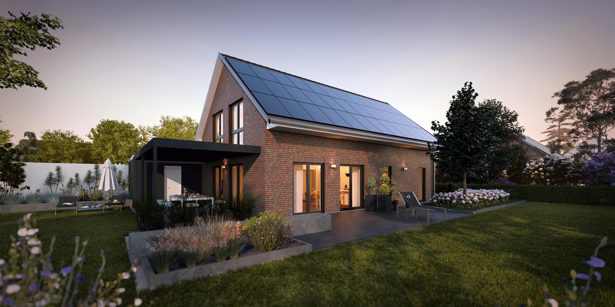 Seitenansicht des Einfamilienhauses V2 von Viebrockhaus. Es handelt sich um ein Klinkerhaus mit einer überdachten Terrasse