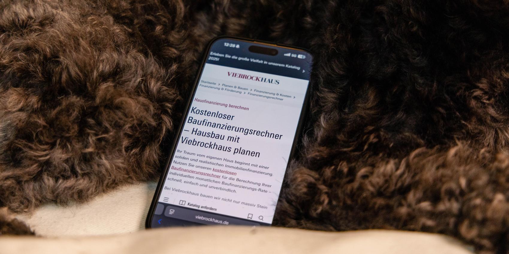 Handy mit Baufinanzierungsrechner.