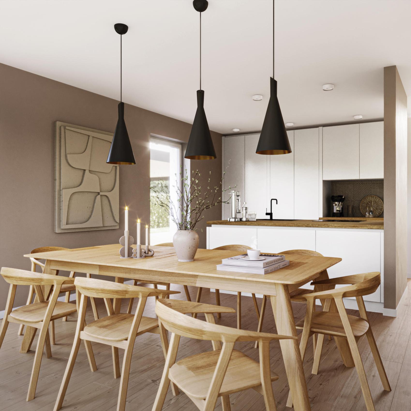 Blick auf einen Essbereich mit offener Küche.