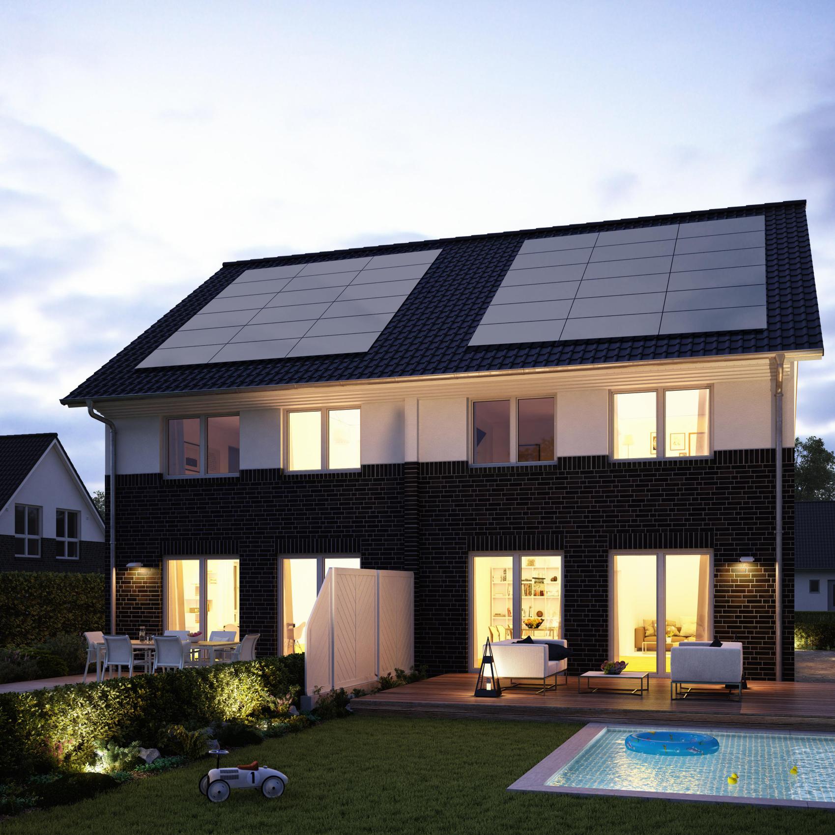 Beleuchtetes Doppelhaus von Viebrockhaus im Abendlicht